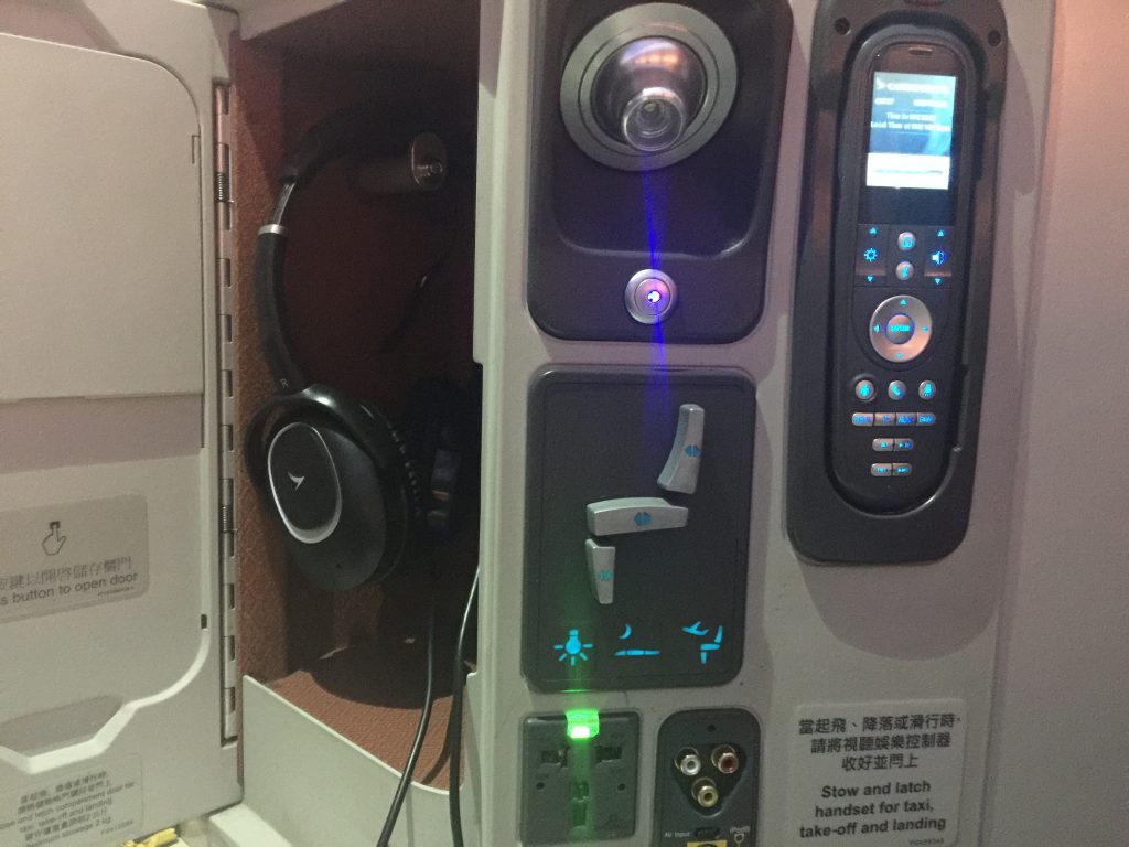 Cathay Pacific Business Class - seat controls headphones ife